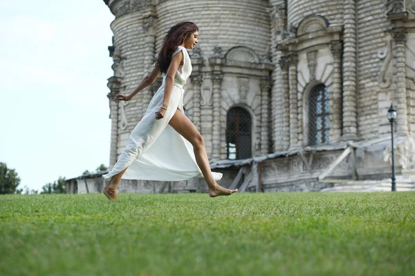 Young woman in a white long dress — Stock Photo, Image