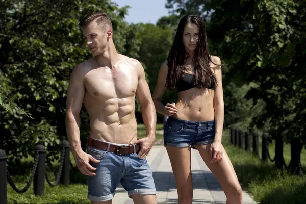 Beautiful sexy young couple in blue jeans — Stock Photo, Image