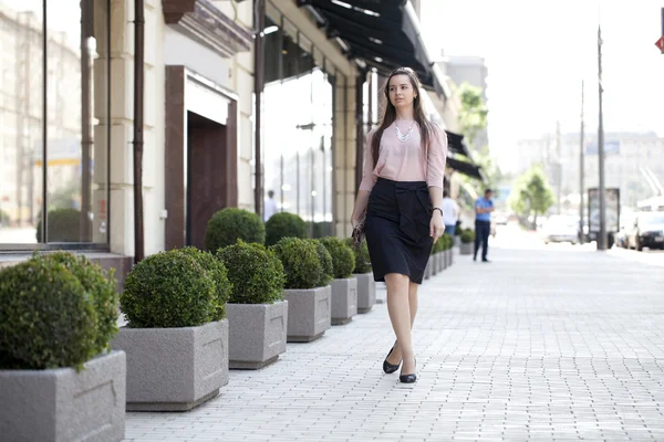 Mladá žena kráčí po ulici — Stock fotografie
