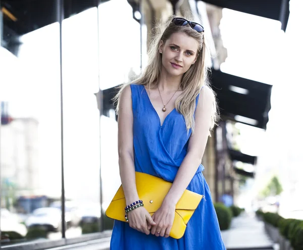 Portrait of the young beautiful woman in blue dress — Stock Photo, Image