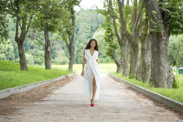 Happy young woman in sexy white dress — Stock Photo, Image