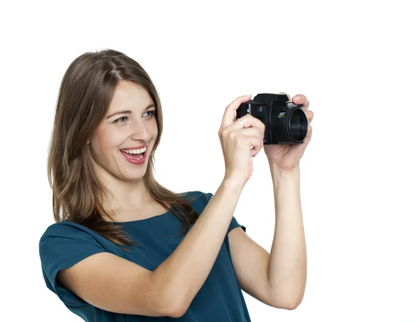 Happy young woman using a camera to take photo — Stock Photo, Image