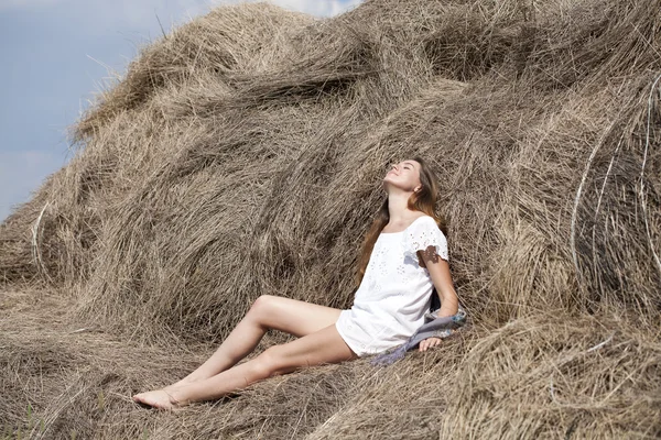 Young beautiful woman in the hayloft in the village — Stock Photo, Image