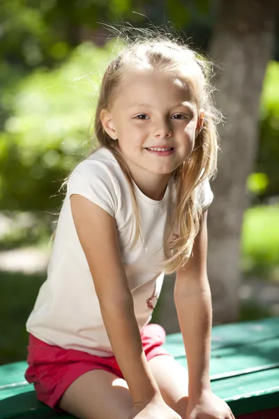 Little happy girl in summer park — Stock Photo, Image