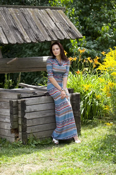 Beautiful young woman in sexy long dress — Stock Photo, Image