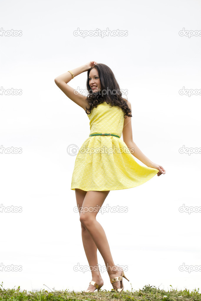 Beautiful young woman in yellow sexy dress