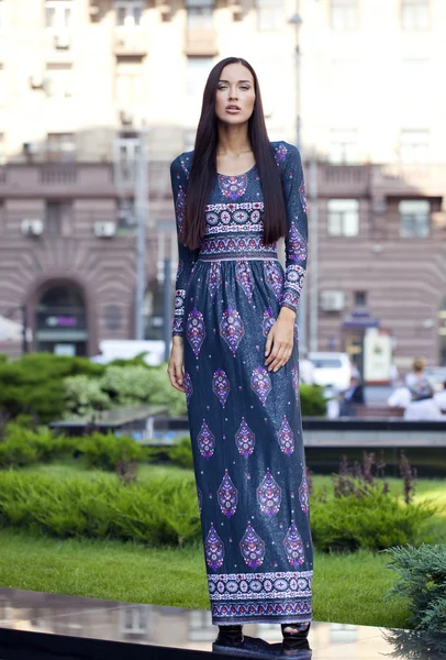 Beautiful young woman in colorful dress — Stock Photo, Image