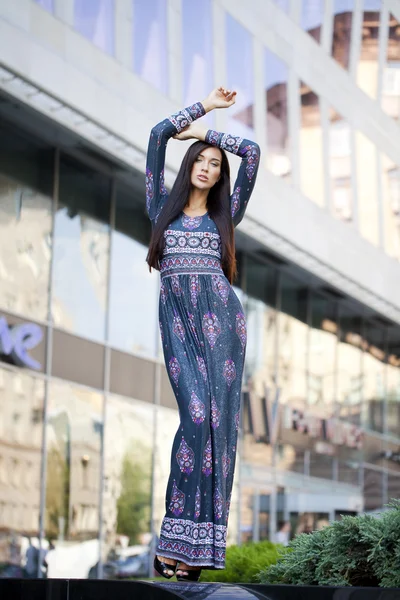 Beautiful young woman in colorful dress — Stock Photo, Image