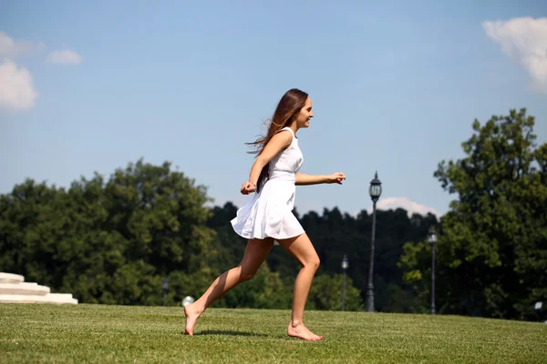 Happy young woman in sexy white dress — Stock Photo, Image