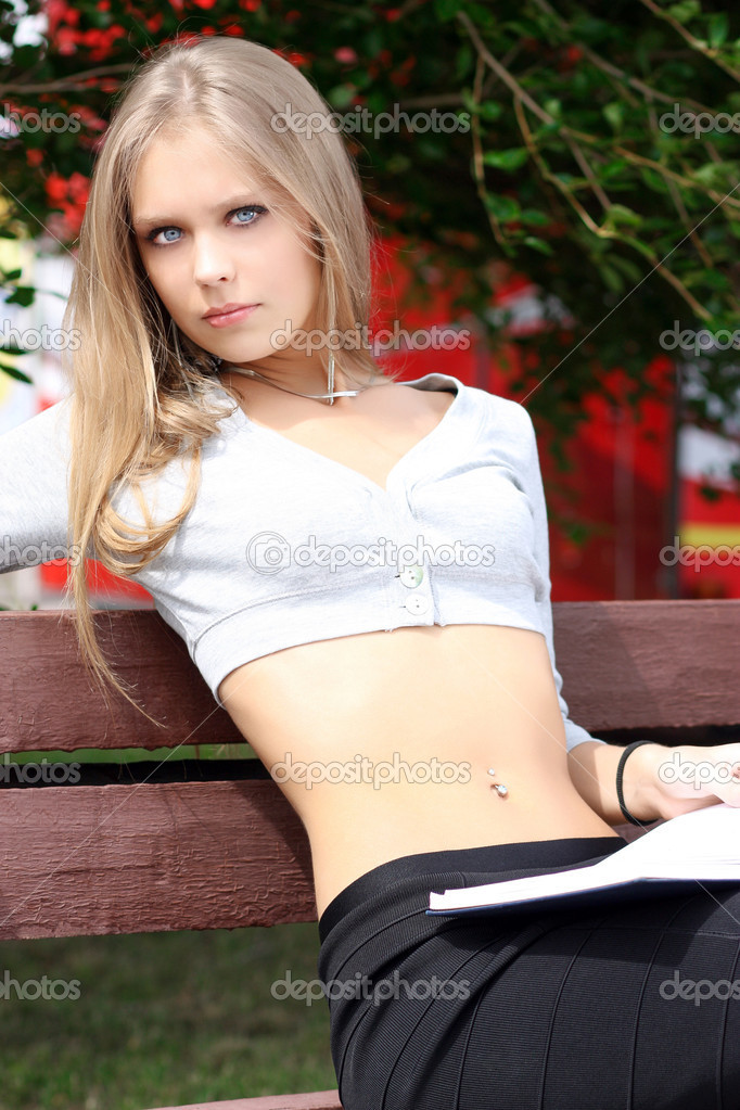 Portrait of blonde young woman sitting on the bench