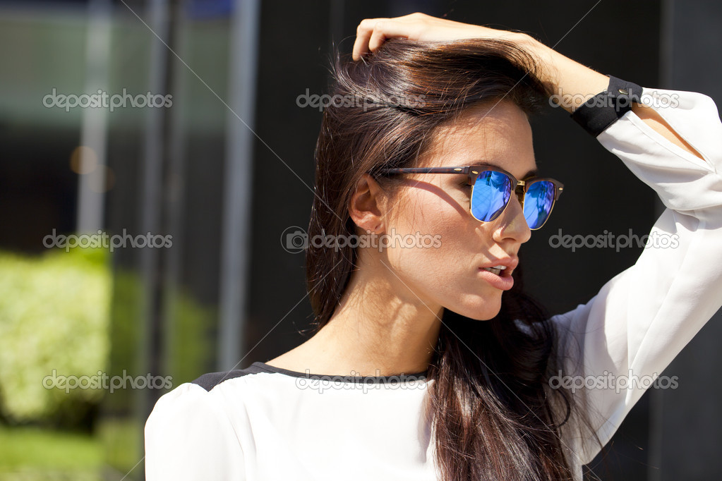 Business woman with blue mirrored sunglasses Stock Photo by