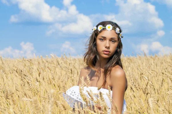 Young woman in a wheat golden field — Stock Photo, Image