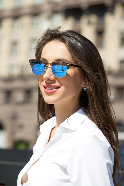 Ділова жінка з блакитними дзеркальними сонцезахисними окулярами — стокове фото