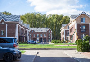 Güz sokağında poz veren sarışın genç kadının tam boy portresi.