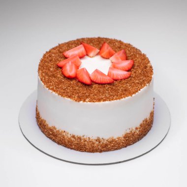 Çilek dilimleriyle süslenmiş ev yapımı ballı pasta.