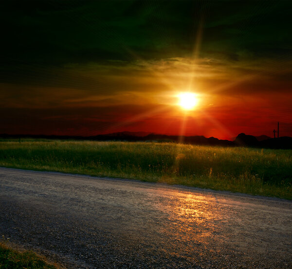 Asphalt road at the sunset
