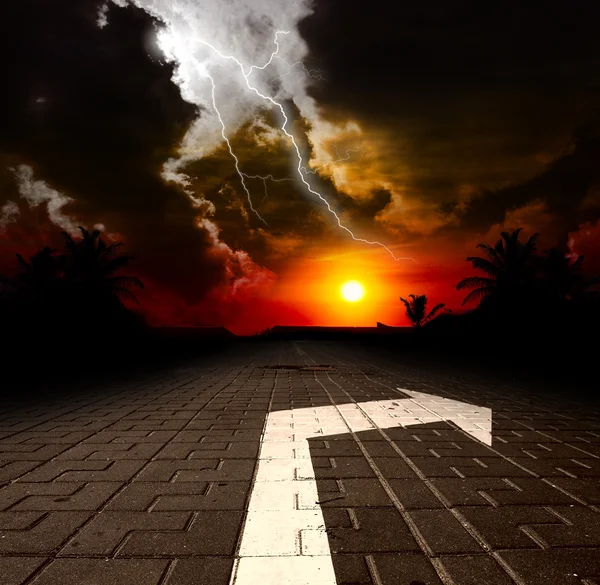 Road with arrow aat the sunset — Stock Photo, Image