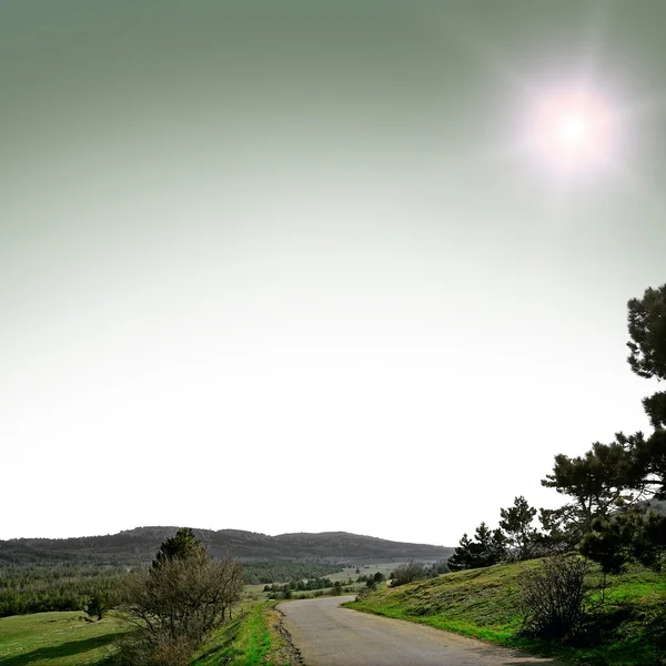 Asphalt road with mountians — Stock Photo, Image