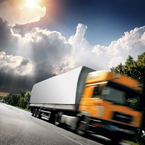 Yellow truck on the asphalt road — Stock Photo, Image