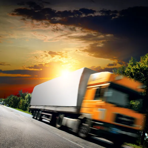 Yellow truck on the asphalt road — Stock Photo, Image