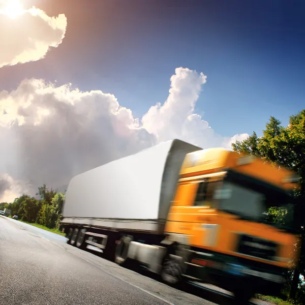 Yellow truck on the asphalt road — Stock Photo, Image