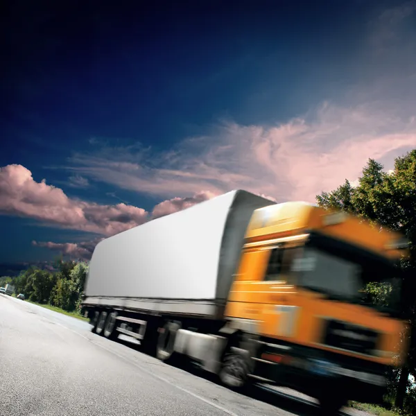 Yellow truck on the asphalt road — Stock Photo, Image