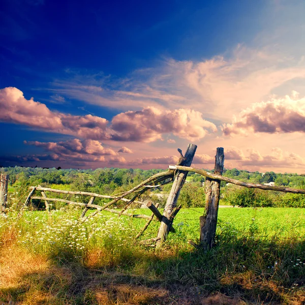 Broken wooden fence on the field