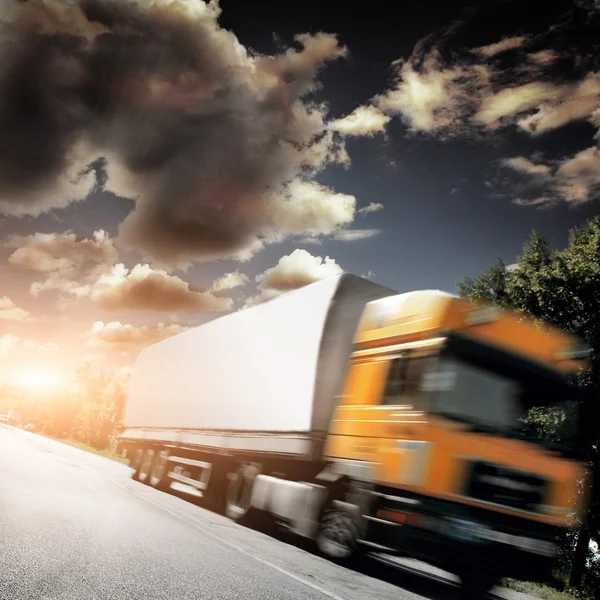 Yellow truck on the asphalt road — Stock Photo, Image