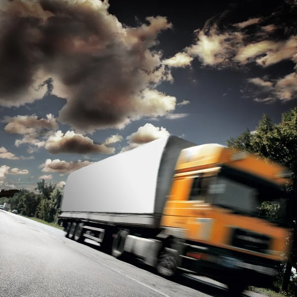 Yellow truck on the asphalt road — Stock Photo, Image