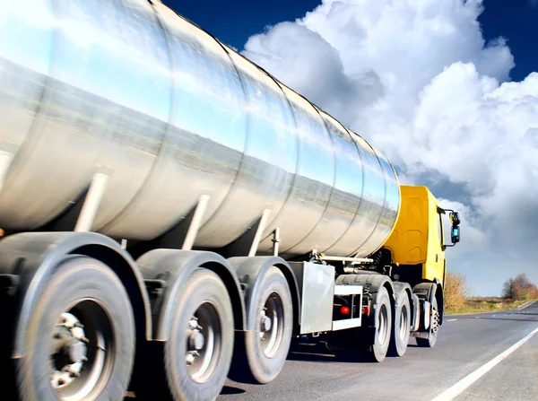 Truck on blurry asphalt road under blue sky and sunset light — Stock Photo, Image