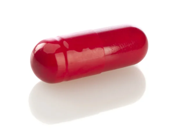 Comprimido da cápsula vermelha isolado no branco — Fotografia de Stock