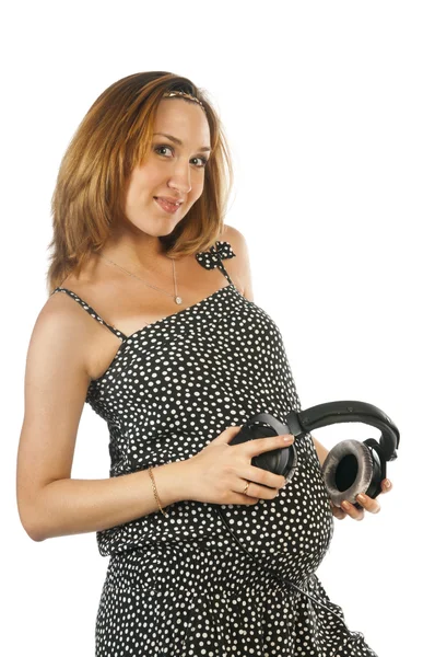 Femme enceinte avec écouteurs — Photo