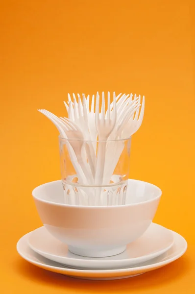 Plates, cup and glass with forks — Stock Photo, Image