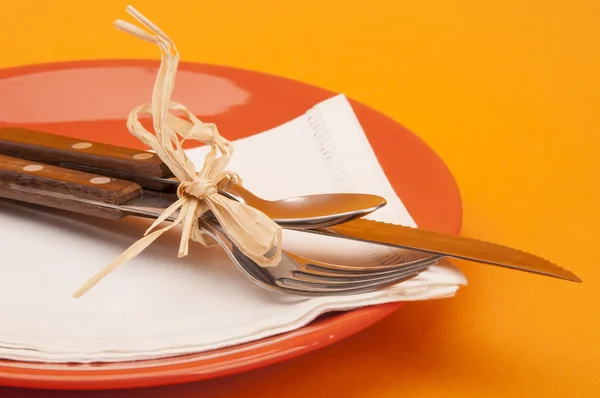 Empty red plates with fork and knife — Zdjęcie stockowe