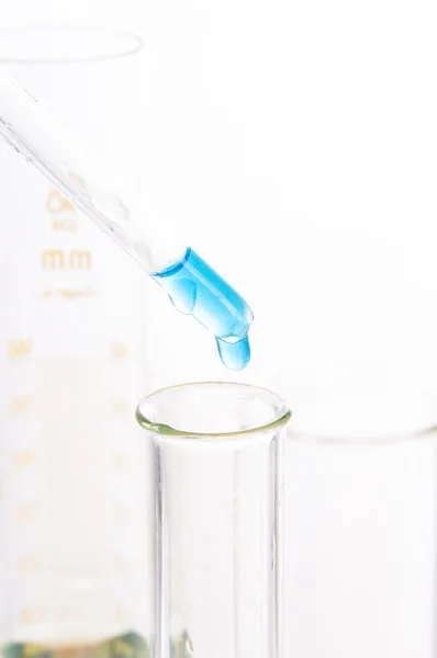 Blue reagent drop into the glass tube — Stock Photo, Image