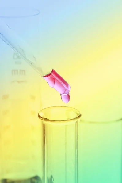 Pink reagent drop into the glass tube — Stock Photo, Image