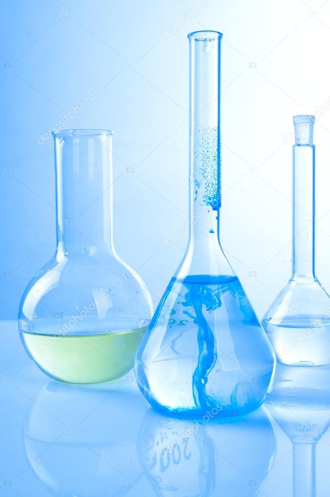 Glass laboratory equipment on blue background