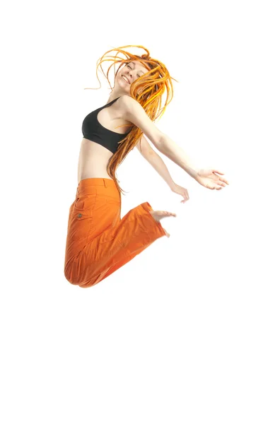 Beautiful girl with red dreadlocks jumping — Stock Photo, Image