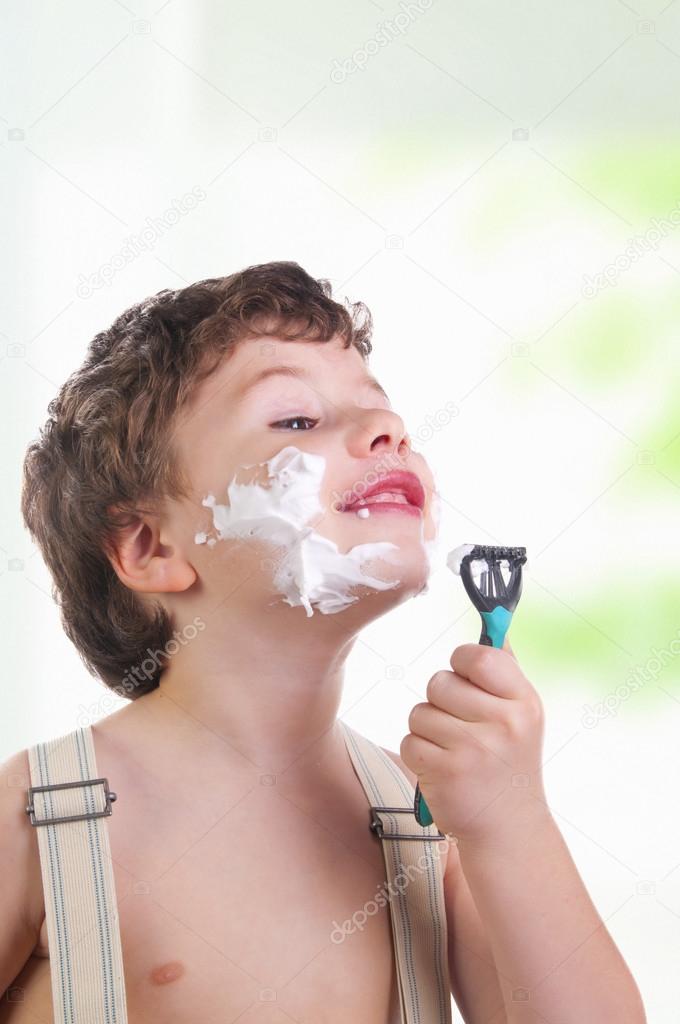 Adorable boy shaving