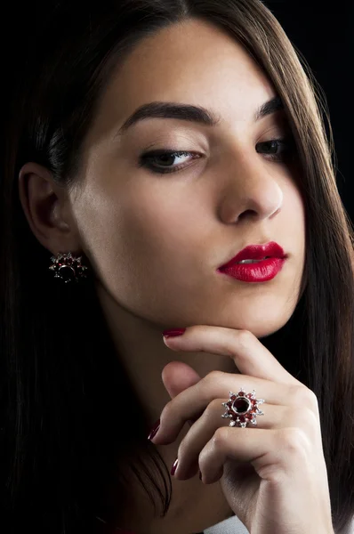 Beautiful woman with silver garnets earrings and ring — Stock Photo, Image