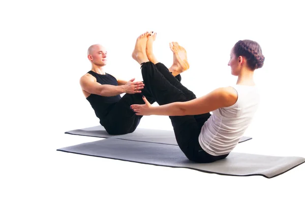 Couple in Navasana pose — Stock Photo, Image