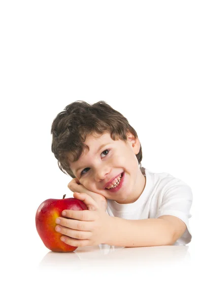 Un bambino sorridente con una mela rossa — Foto Stock
