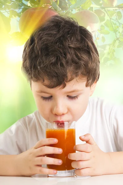 Happy little boy drinking juice — Stock Photo, Image