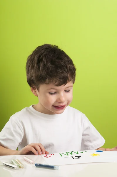 Kleiner Junge mit Buntstiften und seinem Bild — Stockfoto