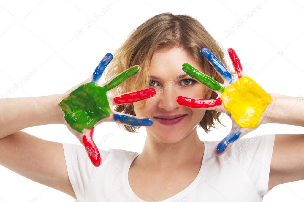 Happy woman with hands painted with colorful paint