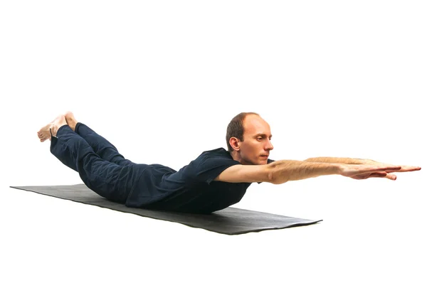 Young man in Makarasana pose — Stock Photo, Image