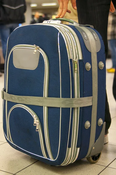 Man with blue luggage bag