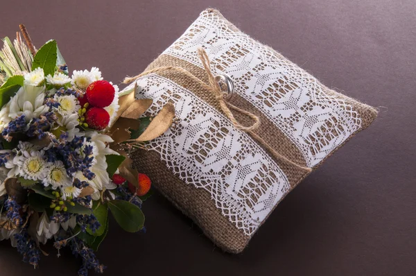 Винтажная свадебная подушка с кольцом и полевыми цветами — стоковое фото