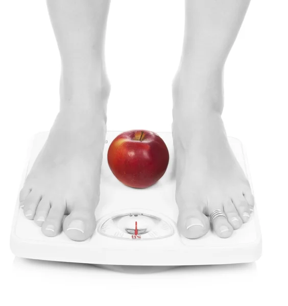 Black and white female feet on scales — Stock Photo, Image