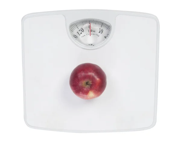 Červené jablko na podlahové váhy — Stock fotografie